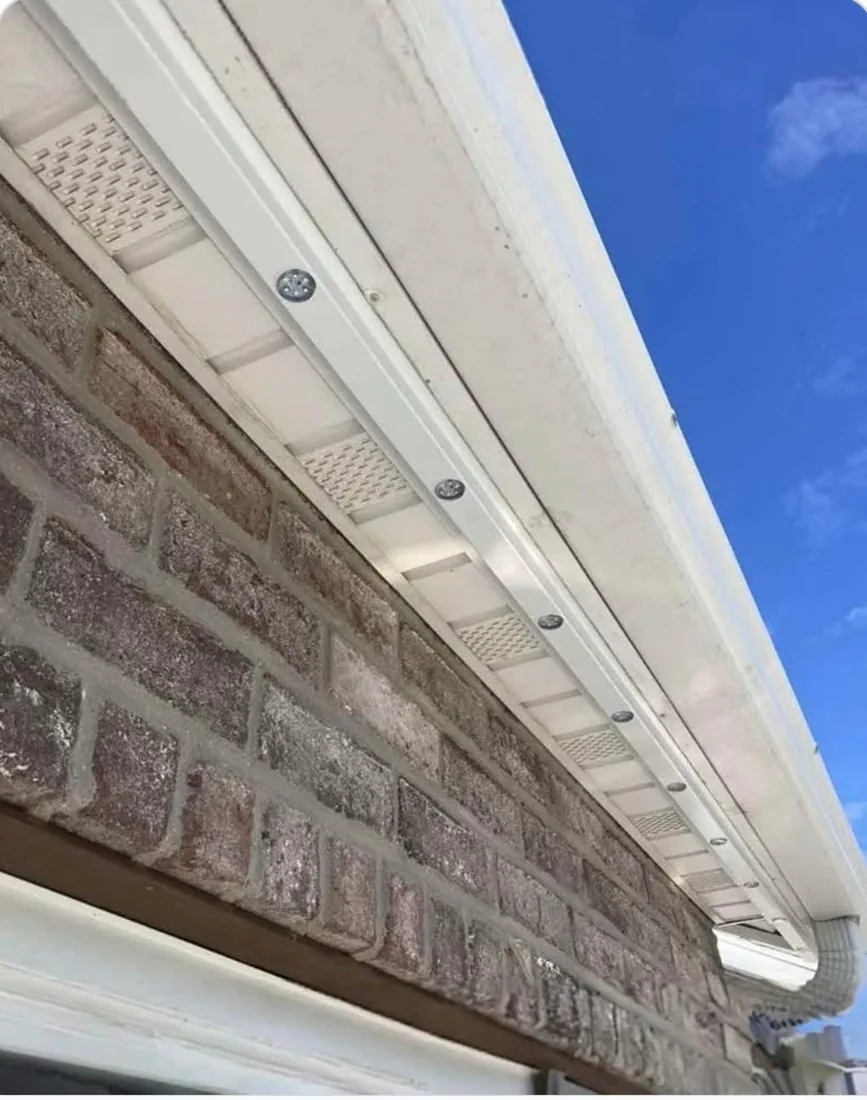 Actual Royal Glow-style white aluminum track with recessed round LED openings under a soffit
